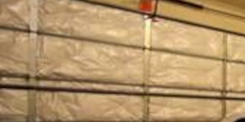 Interior view of a garage door fitted with foil insulation