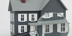 Graphic of a grey house being inspected with a magnifying glass