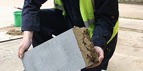 Person holding a grey Marmox Thermoblock brick